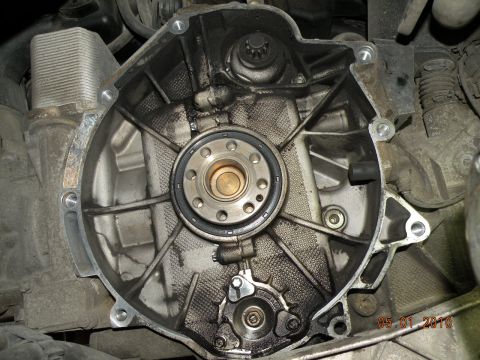 2000 Porsche Carrera - Close-up view of an engine component, likely a seal or bearing housing, showing signs of wear and oil residue.