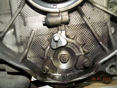 2000 Porsche Carrera - Close-up of an engine component, stamped 'GERMANY', with visible oil and fasteners.