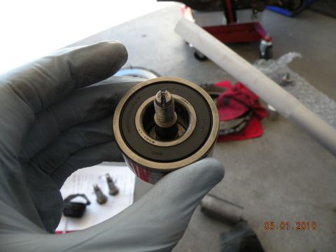 2000 Porsche Carrera - Close-up of a bearing with a bolt, held by a gloved hand. Date stamp reads 05.01.2010.