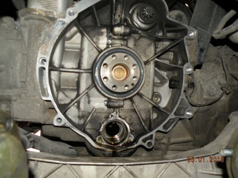 2000 Porsche Carrera - Close-up of an engine part, likely a transmission bell housing, showing internal components and oil stains.
