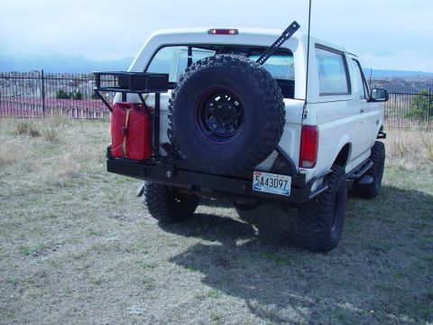 1993 Ford Bronco - Rear view of a 1993 Ford Bronco equipped with off-road accessories including a spare tire and jerry can.
