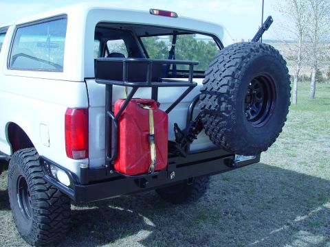 1993 Ford Bronco - This white SUV has a spare tire, jerry can, and custom rear bumper with sliders.