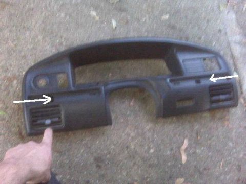 1995 Ford Bronco - A black dashboard section with air vents is shown lying on the ground.