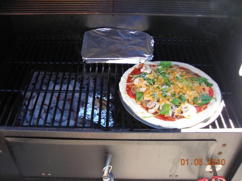 1984 Ford Bronco - A pizza is prepared on a grill next to foil-wrapped food, with a date stamp of 01.05.2010.