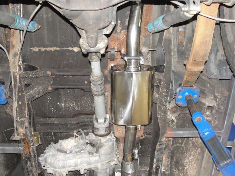 1995 Ford Bronco - Undercarriage shot showing a new exhaust system installation with driveshaft and suspension components.