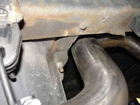 1995 Ford Bronco - Close-up view of the exhaust system and undercarriage components.