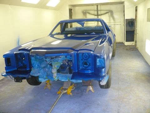 1978 Ford Ranchero - This vehicle is in a paint booth, undergoing restoration with its front end partially disassembled.