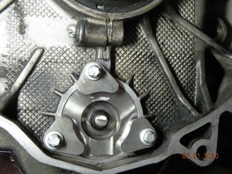 2000 Porsche Carrera - Engine component detail with visible bolts and textured metal casing.