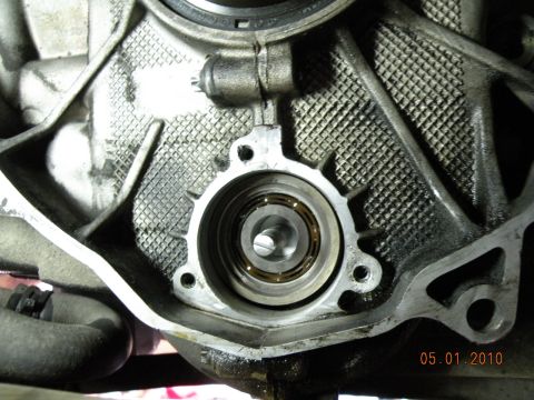 2000 Porsche Carrera - Close-up of an engine component, likely a bearing housing, with visible oil residue and textured metal.