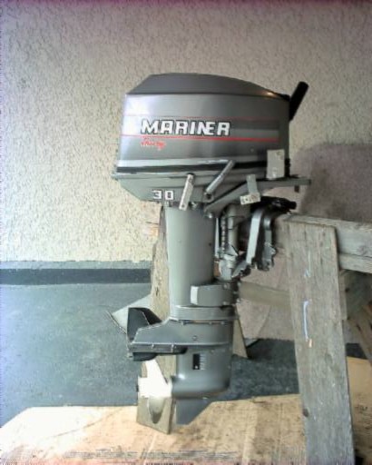 1985 Ford Bronco - A Mariner 30 outboard motor is shown mounted on wooden supports.