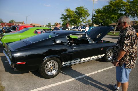 1968 Shelby GT500 - A black 1968 Shelby GT500 is displayed at a car show with its hood up.