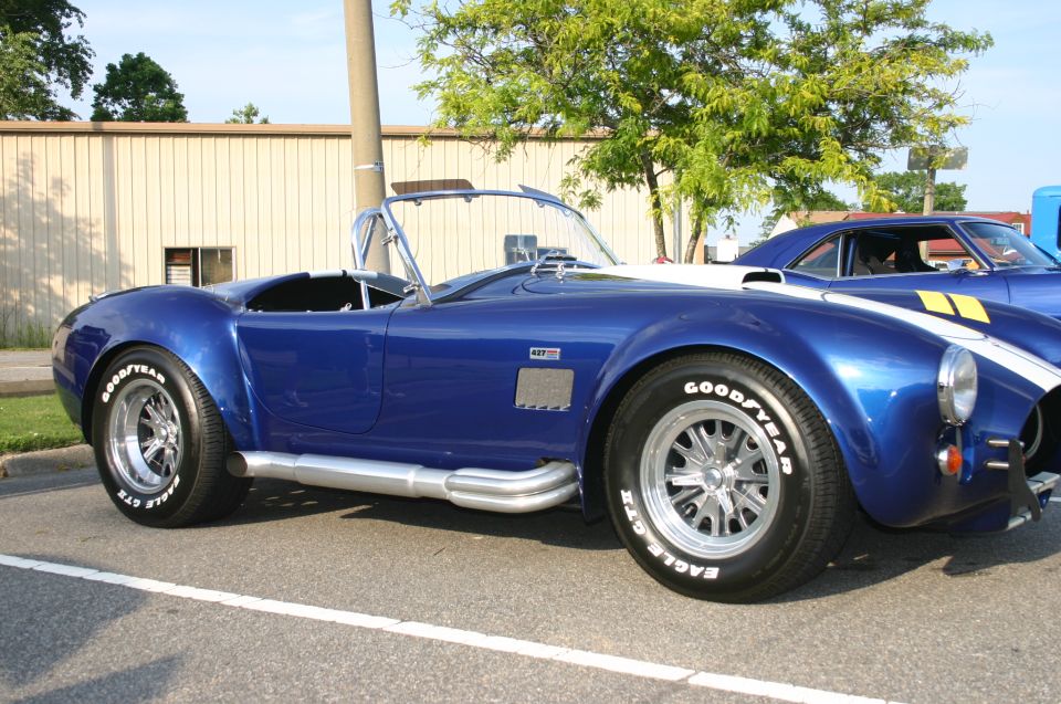 Blue convertible with side pipes and white racing stripes