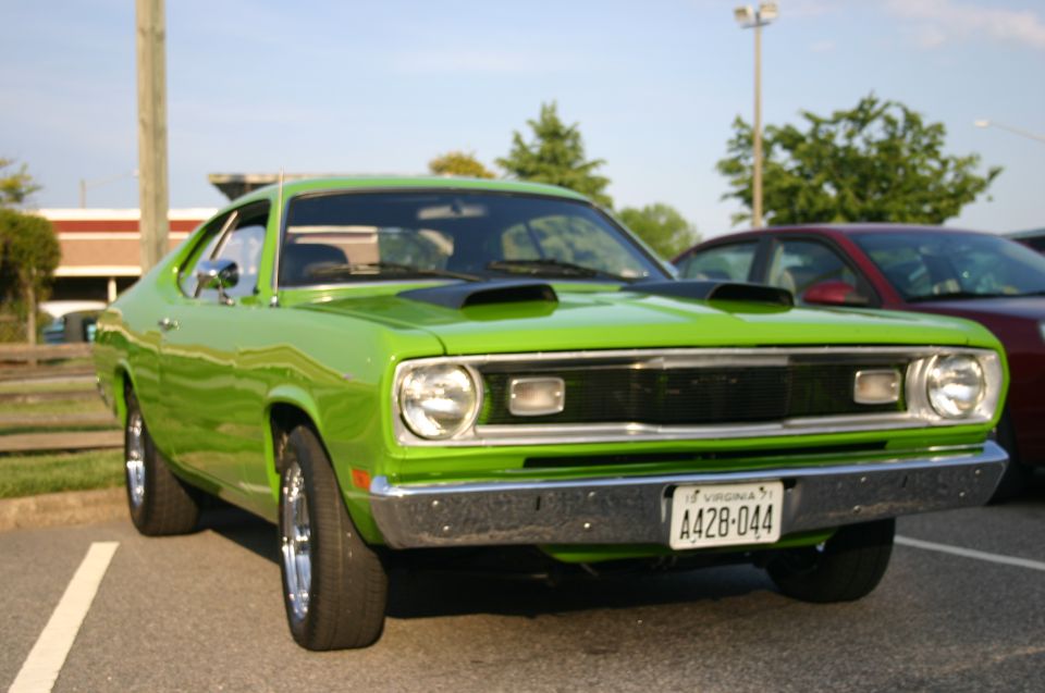 Lime green muscle car with black hood scoops and Virginia license plate A428-044 parked in a lot