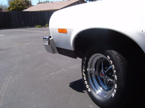 1973 Ford Ranchero - A white 1973 Ford Ranchero is seen from the side, with a chrome bumper and distinctive tires.