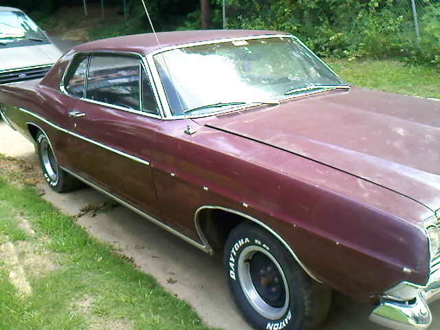 Maroon 1969 Ford Galaxie 500 coupe parked next to a silver vehicle