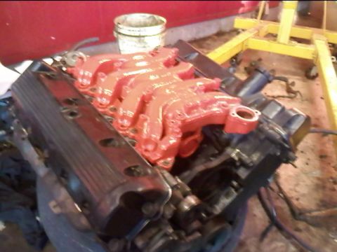 1993 Mercury Grand Marquis - Engine components are visible, including a red intake manifold and black valve covers.