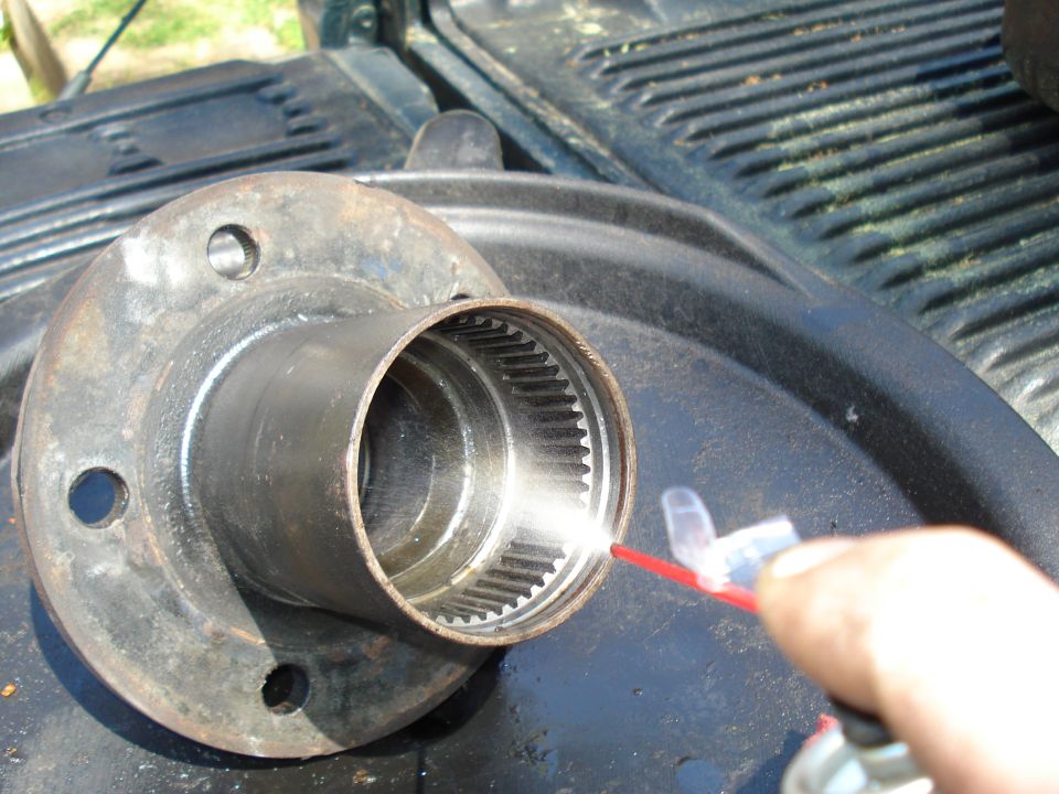 Wheel hub assembly being sprayed with lubricant