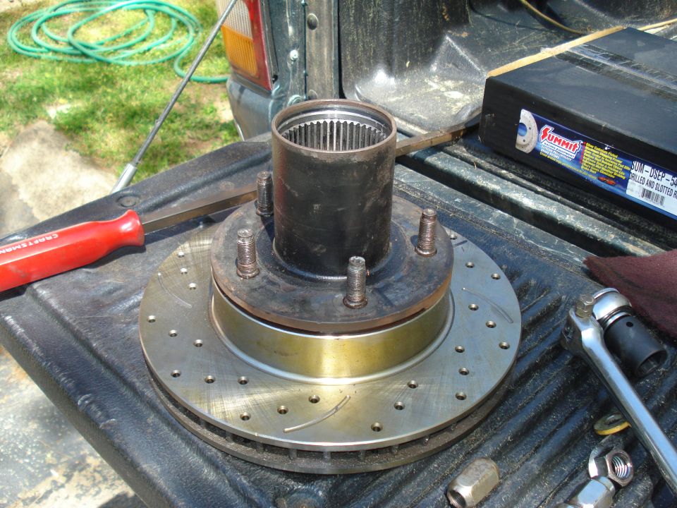Brake rotor and hub assembly with a tool and a box of parts on a truck bed