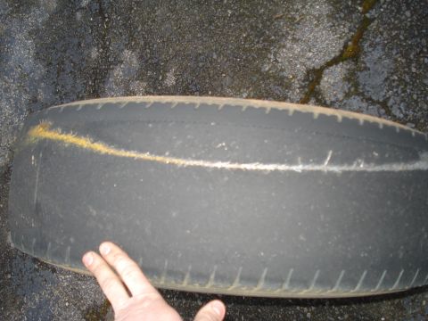 1994 Ford F-350 - A worn tire is shown with painted markings on its tread.