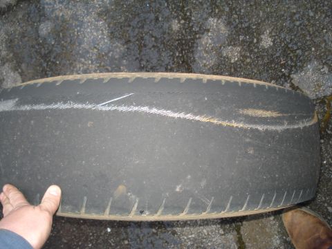 1994 Ford F-350 - A heavily worn tire is shown, with the tread nearly gone and wear indicators exposed.