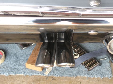 1968 Shelby GT500 - Dual exhaust tips are visible under a chrome bumper, with tools nearby.