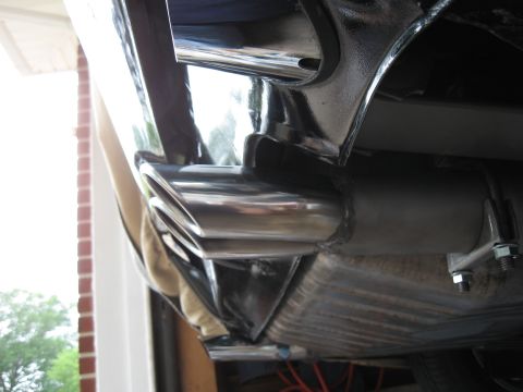 1968 Shelby GT500 - The chrome exhaust tips are angled and polished, attached to a dark-colored vehicle.