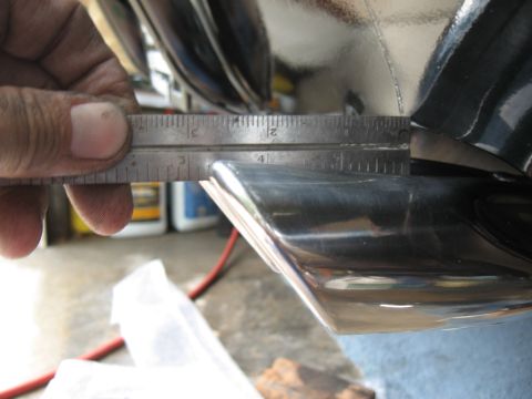 1968 Shelby GT500 - A ruler measures the diameter of a chrome tailpipe tip, indicating its size.
