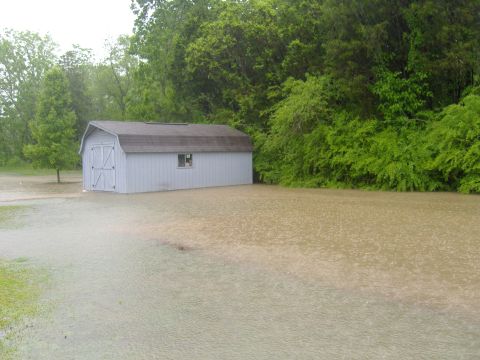 2007 Ford Mustang - A shed and yard are flooded due to heavy rain.