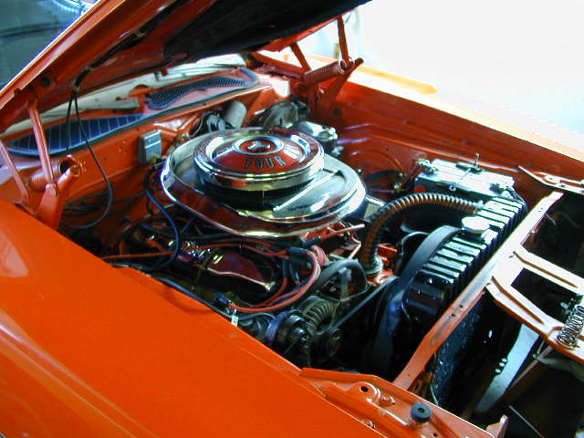 Orange engine bay with chrome air cleaner labeled "FOUR"