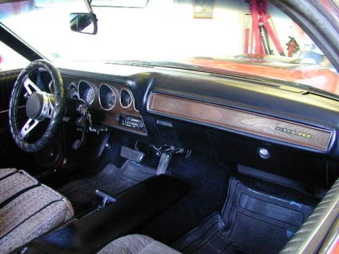 1979 Ford Bronco - Interior of a 1973 Dodge Charger SE, woodgrain trim and a distinctive steering wheel.