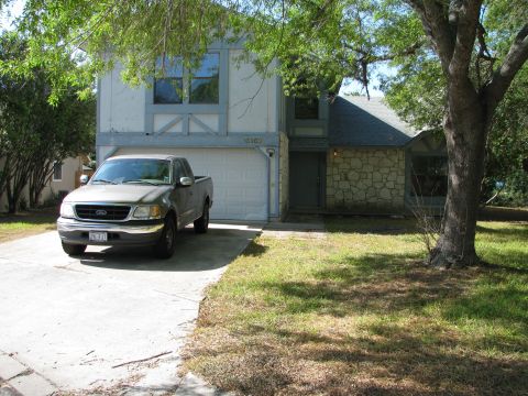 1983 Ford 427 - A silver Ford F-150 pickup truck is parked in the driveway of a two-story house.