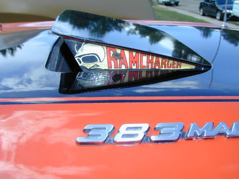 1979 Ford Bronco - Close-up of a car's hood a "RAMCHARGER" scoop and "383 MAG" badging.