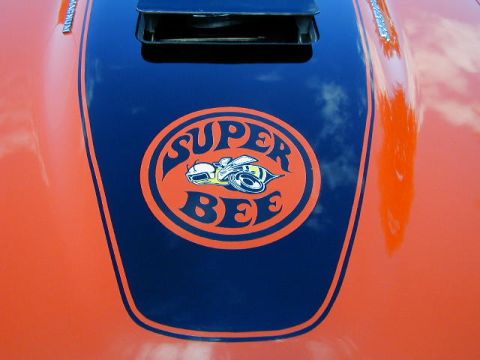 1979 Ford Bronco - The hood features an orange and blue Super Bee emblem, with a scoop and racing stripes.