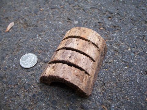 1971 Ford Ranchero - A quarter is placed next to a piece of wood that has been cut four times.