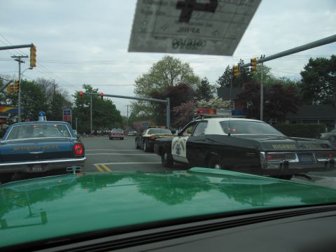 1991 Ford Crown Victoria - Multiple police vehicles are seen at an intersection, including a Highway Patrol car and a Westwood Police car.