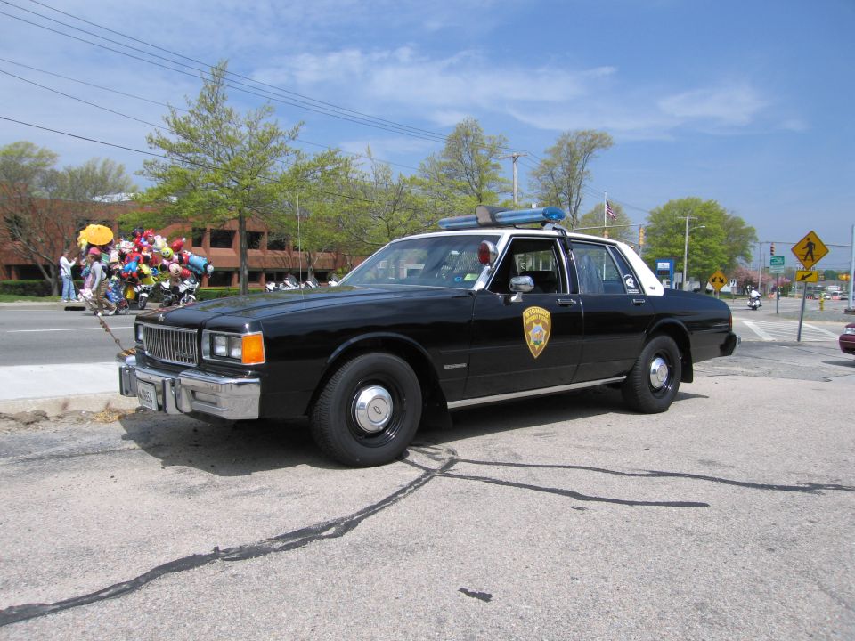 Black-and-white Chevrolet Caprice police sedan with roof lights on a street