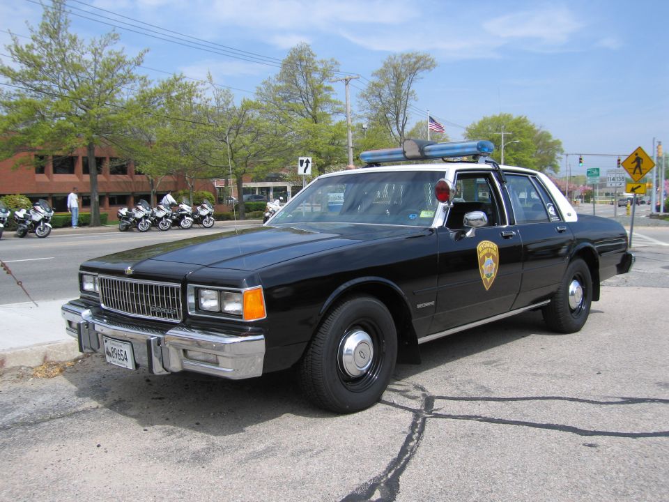 Black-and-white Chevrolet Caprice police sedan front three-quarter view