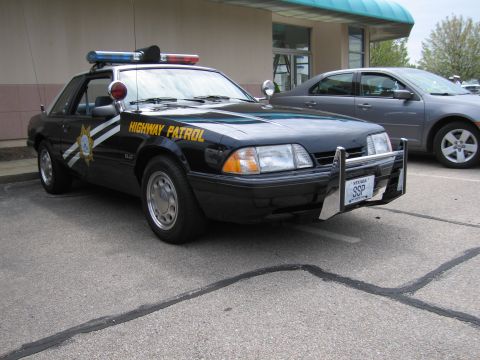 1991 Ford Crown Victoria - This 1991 Ford Mustang SSP police car is parked next to a modern sedan.