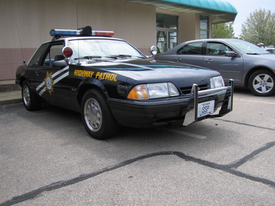 Black Fox-body Ford Mustang lettered HIGHWAY PATROL with push bar and lights