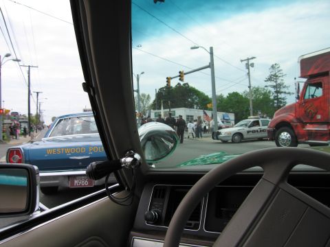 1991 Ford LTD Crown Victoria - View from inside a vehicle showing a blue Westwood Police sedan, a white patrol car and a red truck at an intersection.