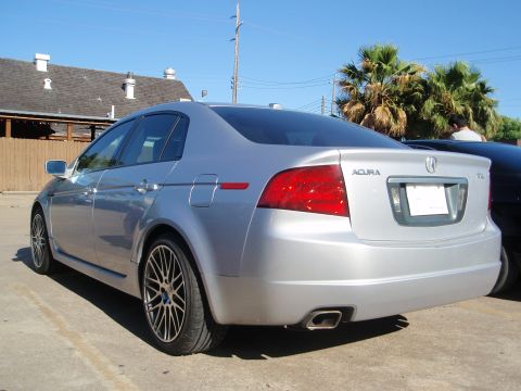 2003 Acura TL - Rear view of a silver 2003 Acura TL sedan, its taillights, exhaust, and alloy wheels.