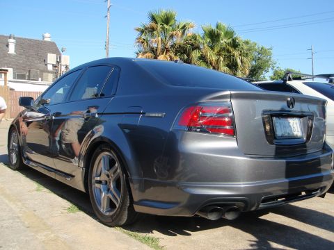 2003 Acura TL - A dark gray Acura TL sedan is parked outdoors on a sunny day, with palm trees in the background.