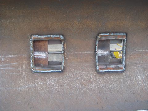 1992 Ford Bronco - Two welded square openings with metal inserts are visible on a rusty metal surface, with a Supermotors.net watermark at the bottom right.