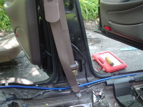 1999 Ford Taurus - This is a picture of the driver side seat belt and lower b pilliar taken from the center of the car looking left.