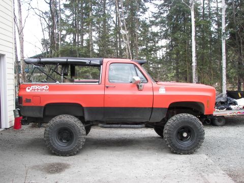 1990 Chevrolet Suburban - This lifted SUV features an 'Offroad' decal on its side and appears to be a Chevrolet K5 Blazer, not a 1990 Suburban.