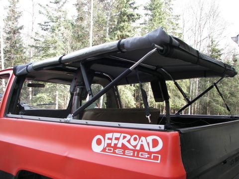 1990 Chevrolet Suburban - This vehicle features an aftermarket canopy and off-road design decals.