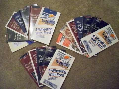 1994 Ford Bronco - Collection of Ford manuals, including '4-Wheeling With Ford' guides, laid out on the floor.