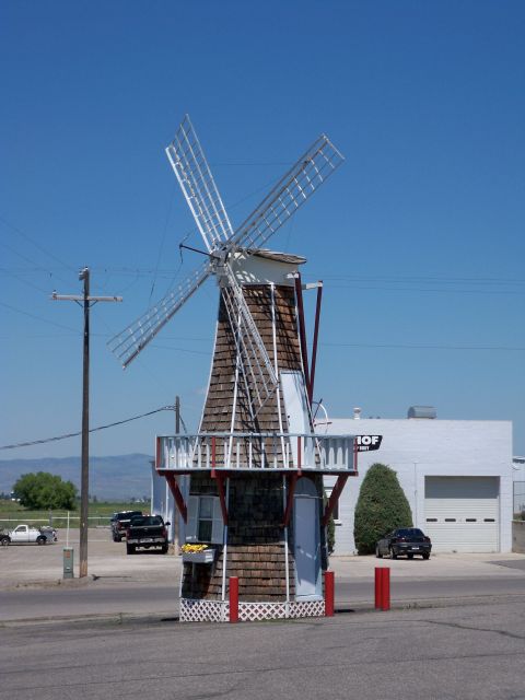 1994 Ford Bronco - A roadside scene a Dutch-style windmill and multiple vehicles parked in front of a commercial building.