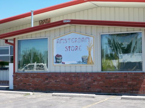 1994 Ford Bronco - Exterior view of the Amsterdam Store building, a painted sign and windows.
