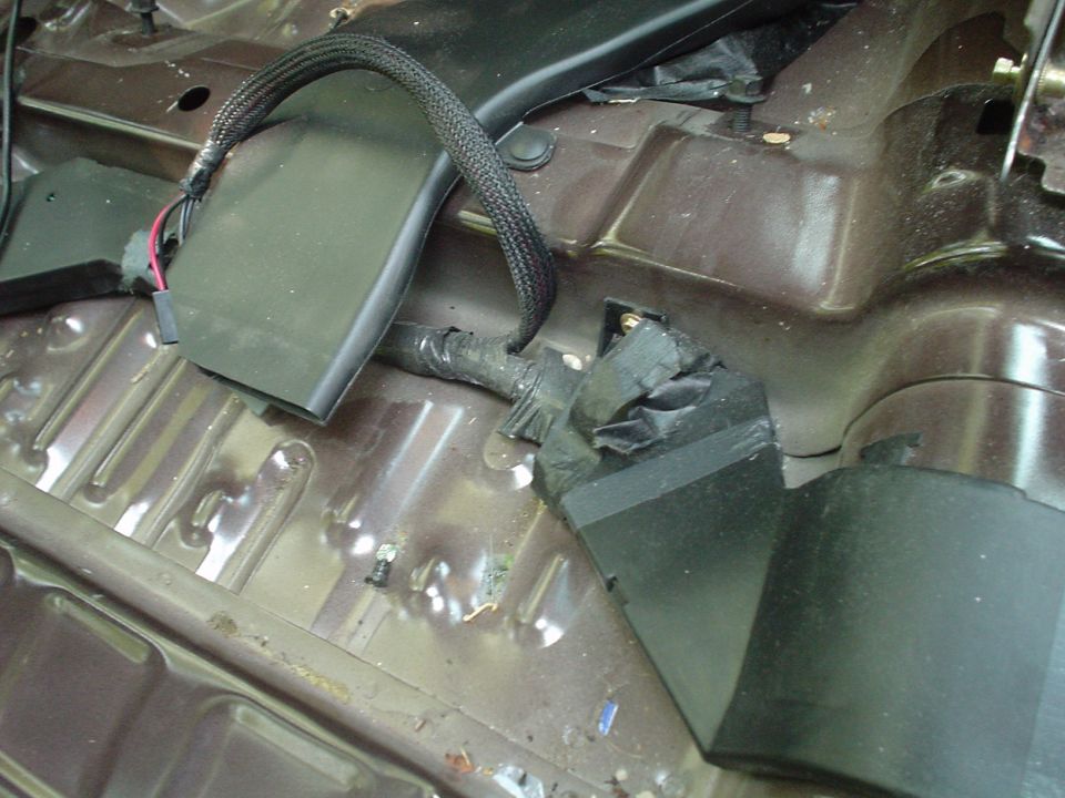 This is a picture of the driver side rear floor vent and power seat connections taken from the center of the car looking forward.